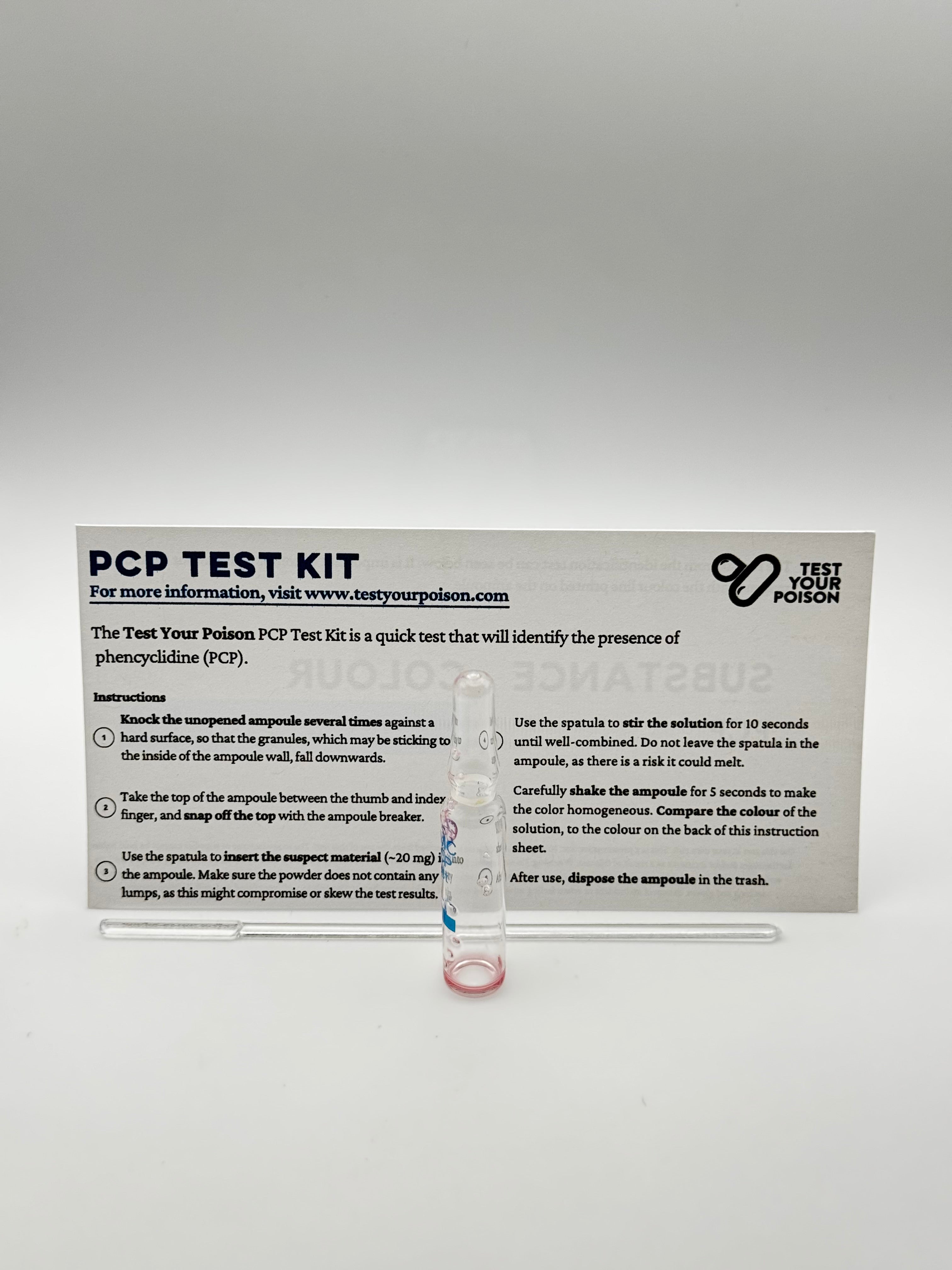 PCP test kit with clear plastic container on a gray background